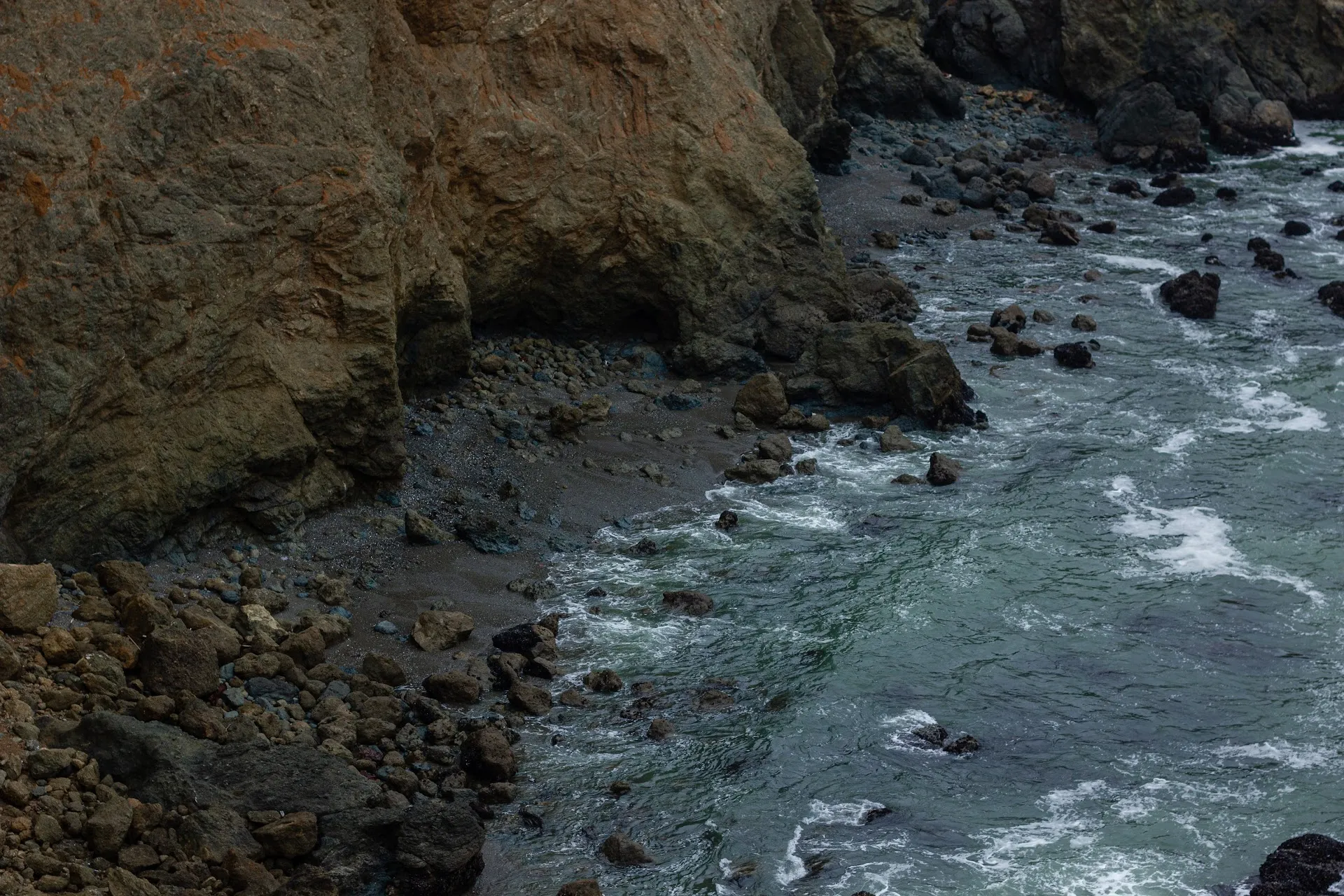 Rocky coastline with waves crashing at Mori Point