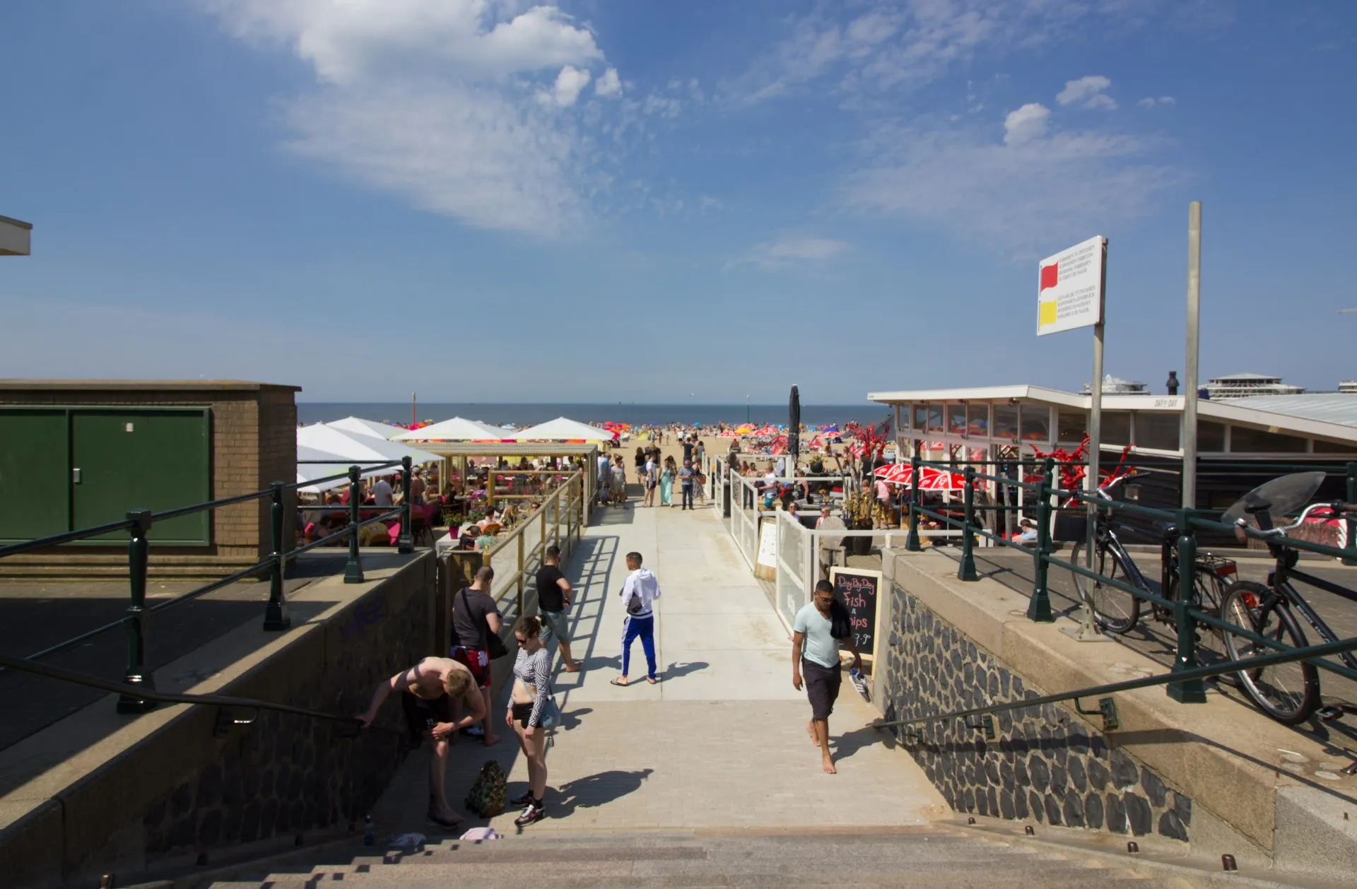 Scheveningen beach boardwalk with people and beach clubs